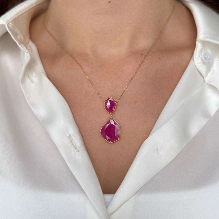Necklace with two ruby slices  worn by a person in a white silk shirt