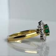 Detailed Side Profile of the Emerald and Diamond Halo Ring, Showcasing the 1.24-Carat Emerald and the Sparkling Diamond Accents.