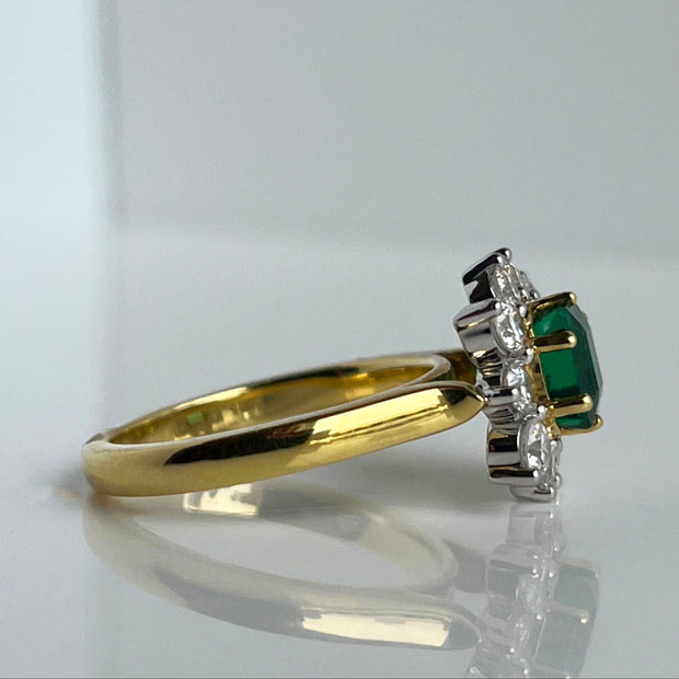 Detailed Side Profile of the Emerald and Diamond Halo Ring, Showcasing the 1.24-Carat Emerald and the Sparkling Diamond Accents.