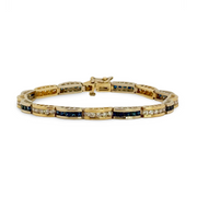 Gold bracelet with blue sapphires and diamonds on a white background