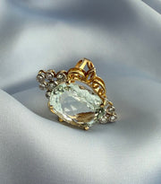 Elegant two-tone gold ring showcasing a radiant aquamarine surrounded by sparkling diamonds.