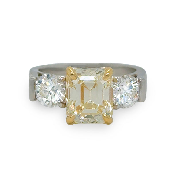 2.80ct Fancy Yellow emerald-cut diamond ring with round side diamonds in platinum and yellow gold