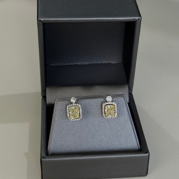 Fancy yellow diamond earrings in a luxury gray jewelry box 