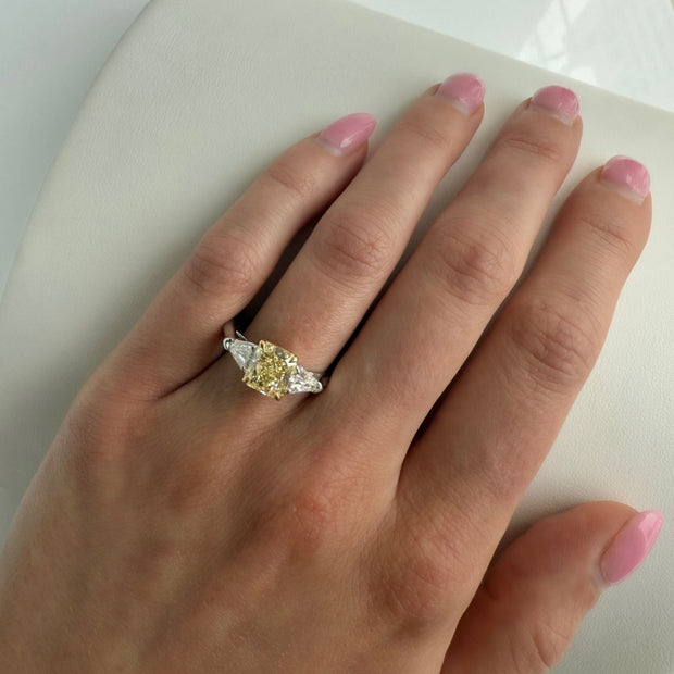 Luxury two-tone diamond ring worn on finger, highlighting yellow and white diamonds