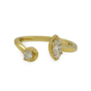 Close-up of marquise and round diamond bypass ring in polished yellow gold