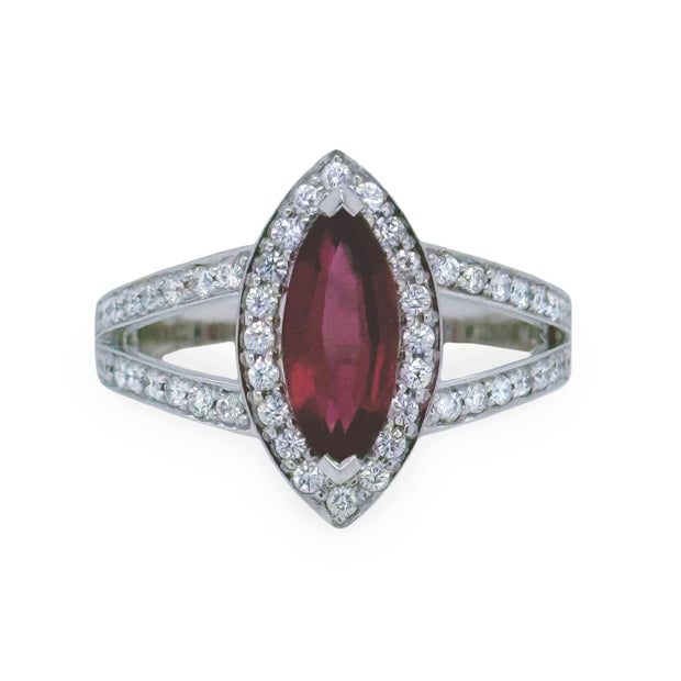 Ring with a marquise-shaped pink tourmaline gemstone and diamond-studded band on a white background