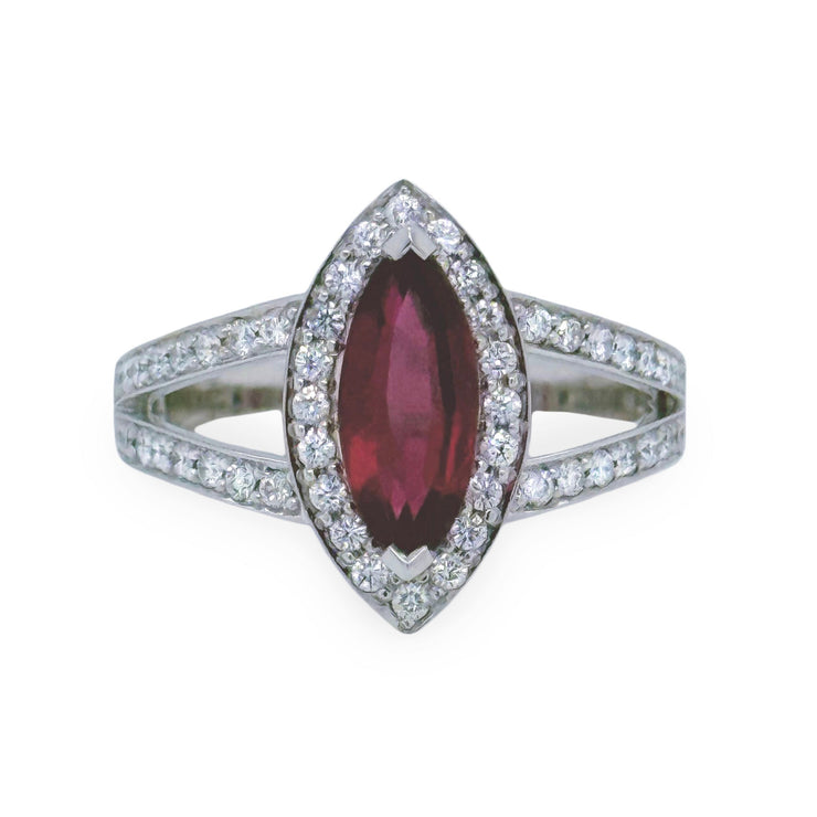 Ring with a marquise-shaped pink tourmaline gemstone and diamond-studded band on a white background