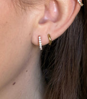 Mini diamond hoop earrings in ose gold on model.