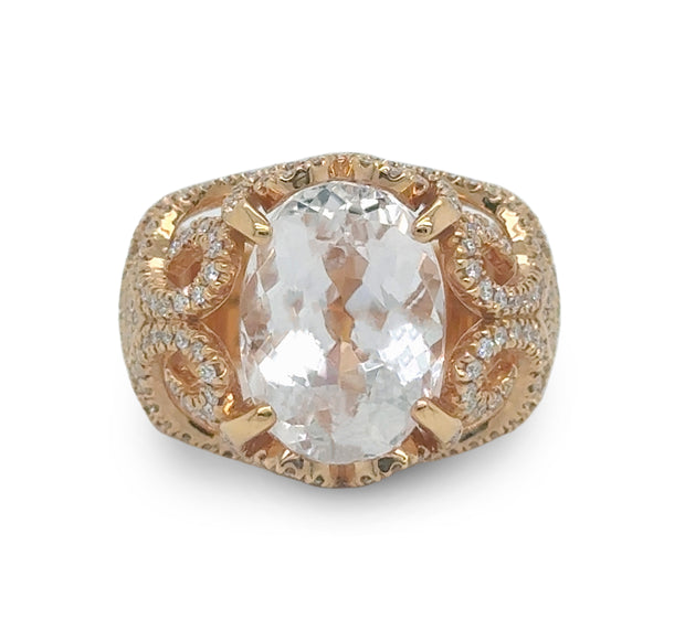 Close-up of blush-pink Morganite engagement ring with diamond halo set in rose gold