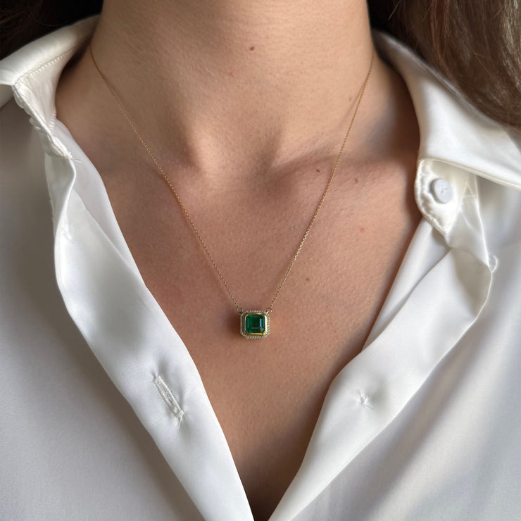 Versatile 18-inch necklace featuring a natural 1.80 ct green emerald and accent diamonds totaling 0.07 ct, set in luxurious 18K yellow gold on a mode.