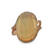 Ring with a large opalgemstone and rose gold band on a white background