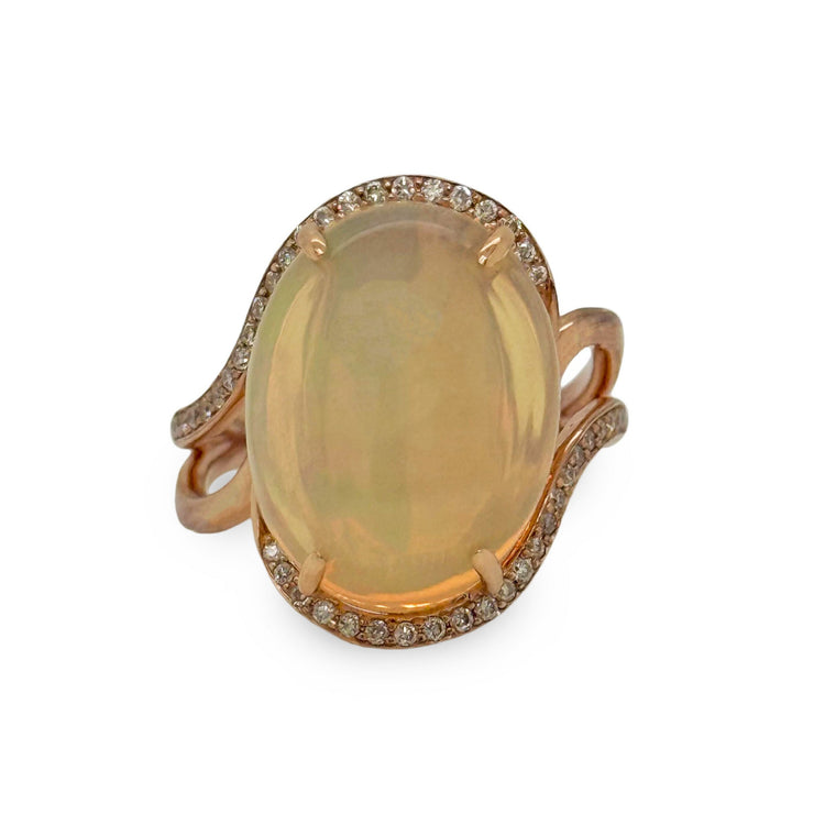 Ring with a large opalgemstone and rose gold band on a white background
