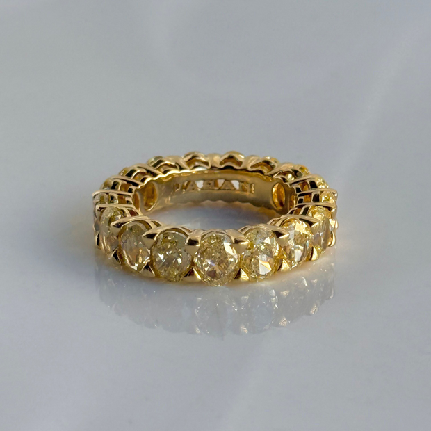 Gold eternity ring with oval fancy yellow diamond stones 