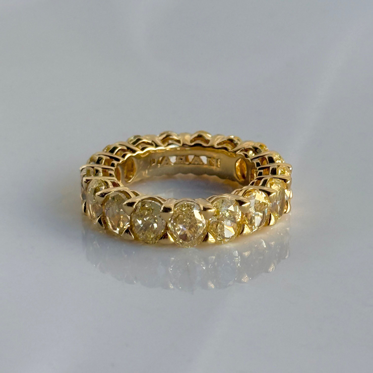 Gold eternity ring with oval fancy yellow diamond stones 