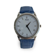Piaget wristwatch with blue strap and silver case on a white background
