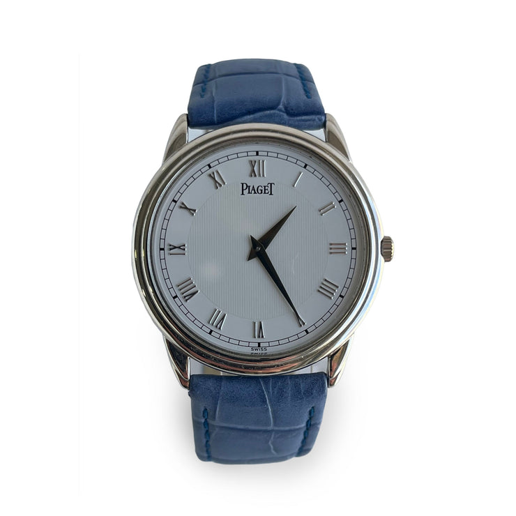 Piaget wristwatch with blue strap and silver case on a white background