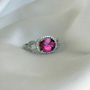 Luxury gemstone ring with a striking tourmaline centerpiece and round brilliant diamond accents in white gold