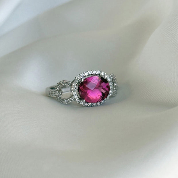 Luxury gemstone ring with a striking tourmaline centerpiece and round brilliant diamond accents in white gold
