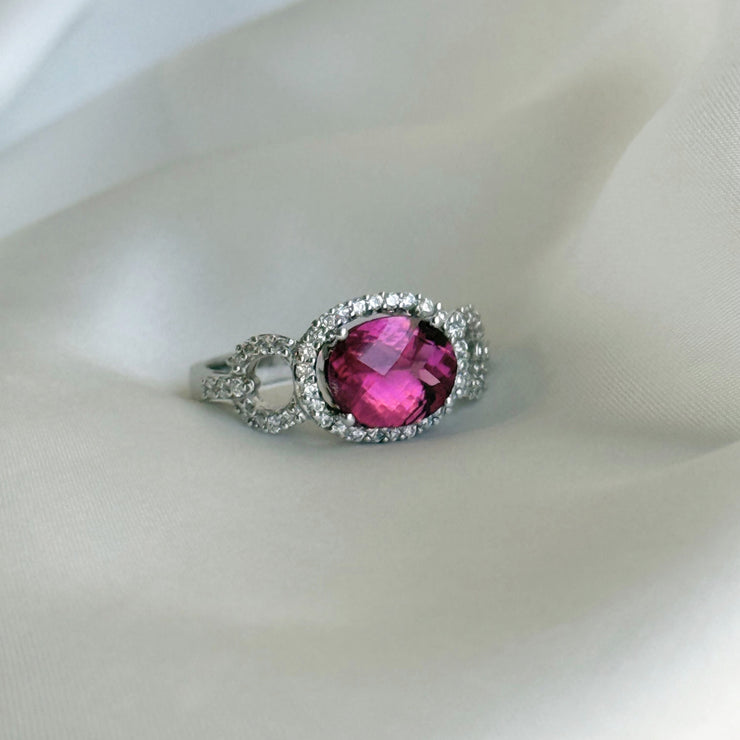 Luxury gemstone ring with a striking tourmaline centerpiece and round brilliant diamond accents in white gold