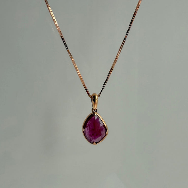 Elegant ruby slice pendant necklace in rose gold, perfect for layering or as a statement piece.