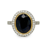 Bezel-set 6.60 ct oval sapphire and 2.00 ctw diamond ring in platinum with yellow gold