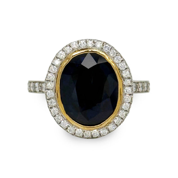 Bezel-set 6.60 ct oval sapphire and 2.00 ctw diamond ring in platinum with yellow gold