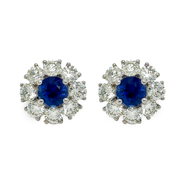 Pair of earrings with brilliant blue sapphires and diamond halos.
