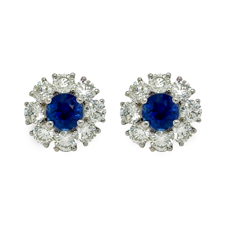 Pair of earrings with brilliant blue sapphires and diamond halos.