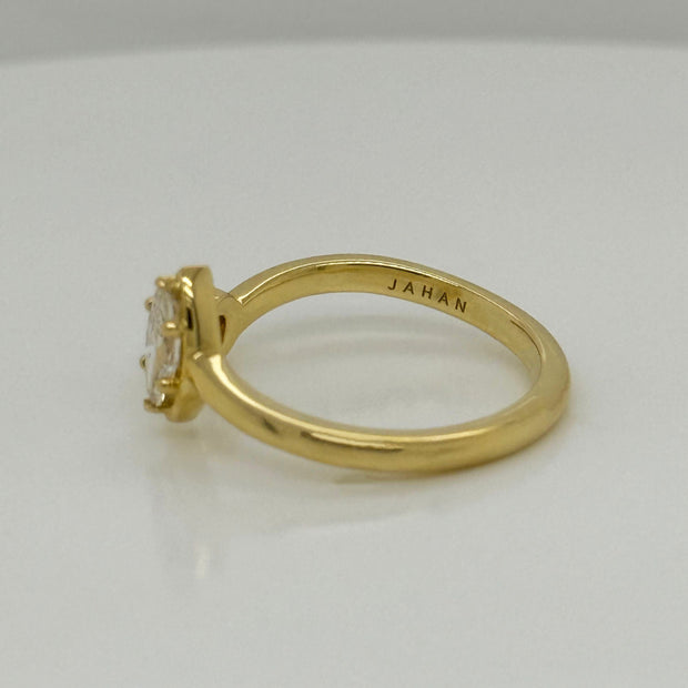 Delicate 18K gold ring showcasing marquise and round diamonds in bypass setting