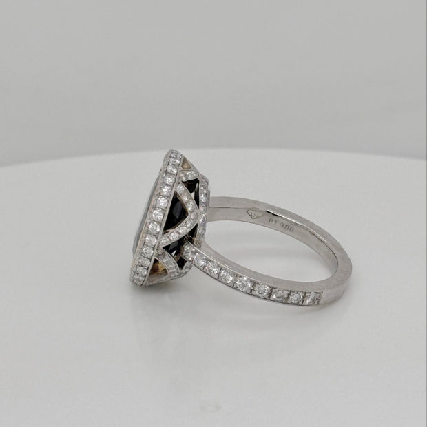 Luxury sapphire and diamond ring featuring a bezel-set 6.60 ct oval blue sapphire with diamond accents