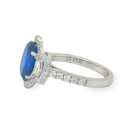 Side view of the 3.49ct oval cut sapphire and diamond ring, showcasing the sleek 18K white gold setting and the brilliance of the surrounding diamonds.