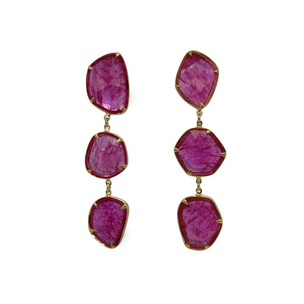 Pair of earrings with red pink natural ruby slice gemstones on a white background