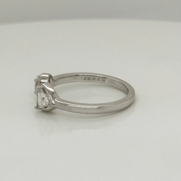 Elegant bypass ring symbolizing unity, set with oval and trillion cut diamonds