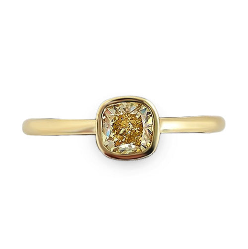 Modern yellow gold diamond ring showcasing a 0.53 carat fancy yellow diamond in a smooth bezel setting.