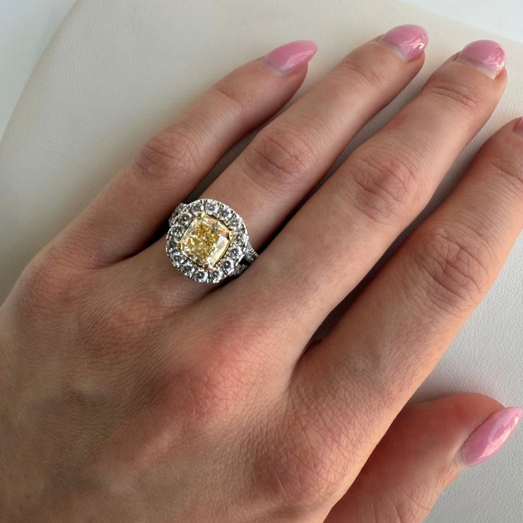Model wearing 3.01 carat Fancy Yellow Diamond ring with diamond halo, set in 18K yellow and white gold.