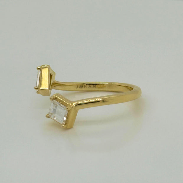 Two-stone bypass ring with geometric emerald and baguette diamonds in yellow gold