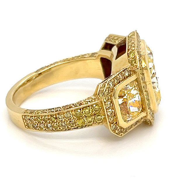 Yellow diamond three stone halo ring