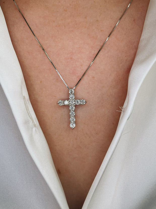 Elegant 1.00ct diamond cross pendant necklace shown on model.