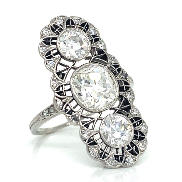 This elegant Edwardian dinner ring features a 1.75ct old cushion-cut diamond, flanked by 1.10ctw of round European cut diamonds, and surrounded by a lace-like halo of smaller diamonds, all set in platinum. 