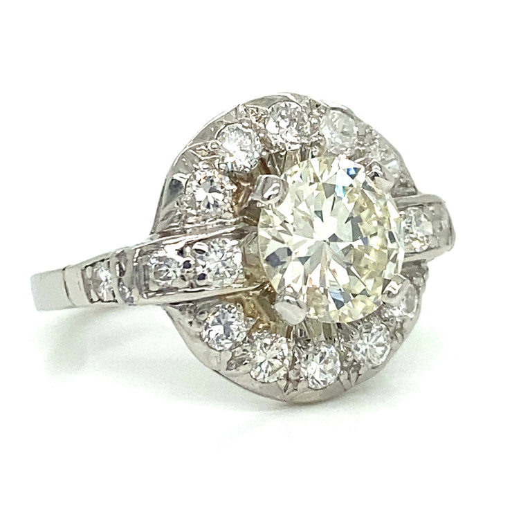Every angle captures the beauty of this platinum ring, with a glowing 1.20 ct center diamond surrounded by a graceful halo and diamond band that shimmers with soft brilliance.