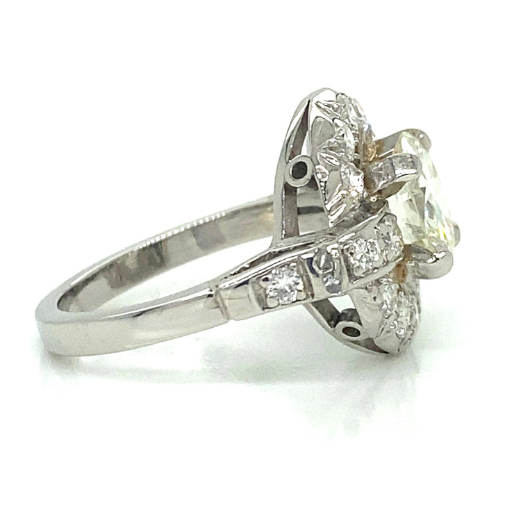Crafted in platinum, this ring blends antique charm with elegant sparkle