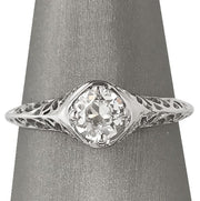 Front, close view of the ring showing the Old European cut diamond framed by ornate white gold filigree.