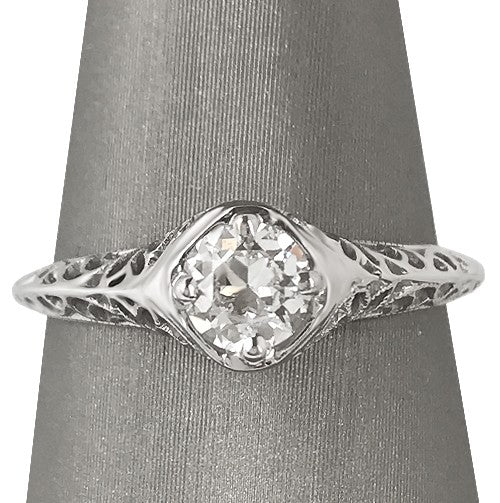 Front, close view of the ring showing the Old European cut diamond framed by ornate white gold filigree.