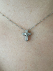 Delicate and full of sparkle this diamond cross pendant shines on model.