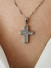 A detail close up of the diamond pendant on model.