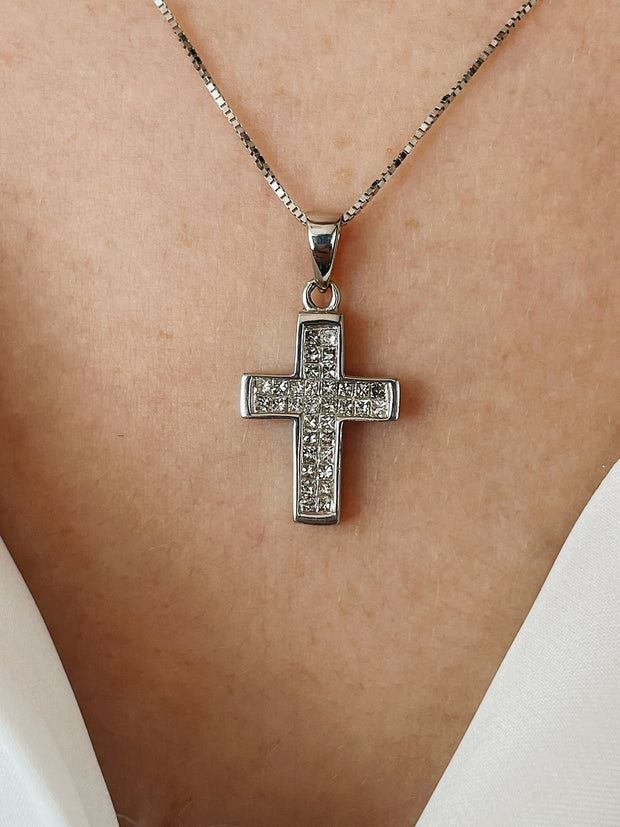 A detail close up of the diamond pendant on model.
