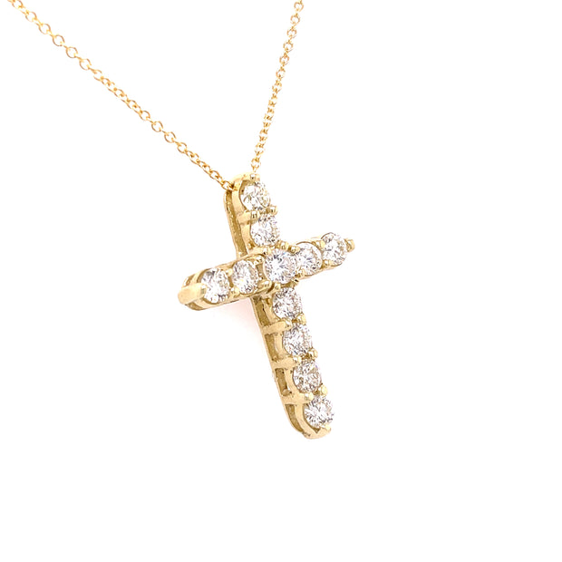 Yellow gold diamond cross pendant.