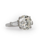 Celebrate your love with this breathtaking engagement ring, showcasing a spectacular 6.60 carat round brilliant cut diamond.