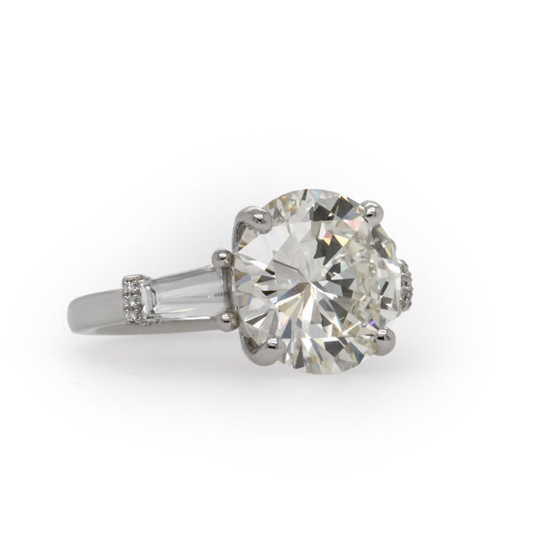 Celebrate your love with this breathtaking engagement ring, showcasing a spectacular 6.60 carat round brilliant cut diamond.