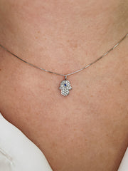 Delicate diamond and sapphire Hamsa pendant.